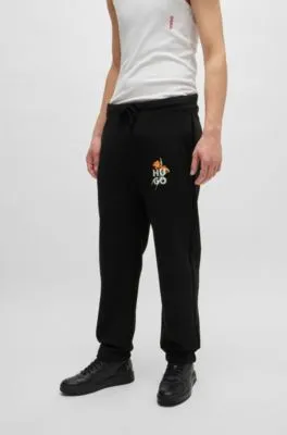 Relaxed-fit tracksuit bottoms with floral logo artwork