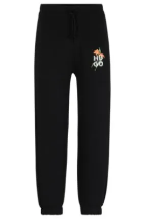 Relaxed-fit tracksuit bottoms with floral logo artwork