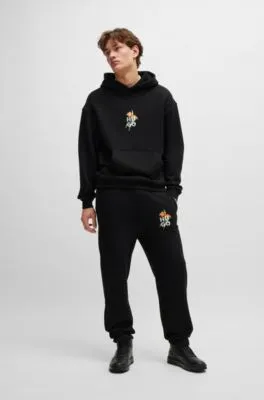 Relaxed-fit tracksuit bottoms with floral logo artwork