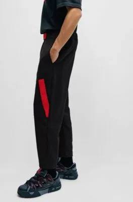 Relaxed-fit tracksuit bottoms with red logo tape