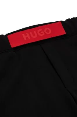 Relaxed-fit tracksuit bottoms with red logo tape