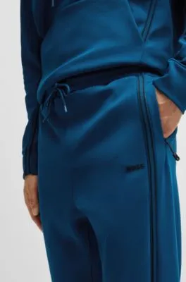 Tracksuit bottoms with tape inserts